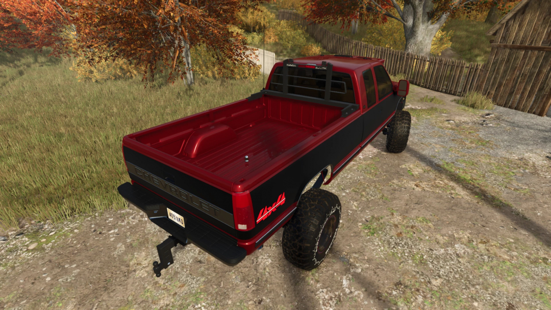 FS25 1990 Chevy K2500 mod parked near autumn trees, showing truck bed and rural setting.