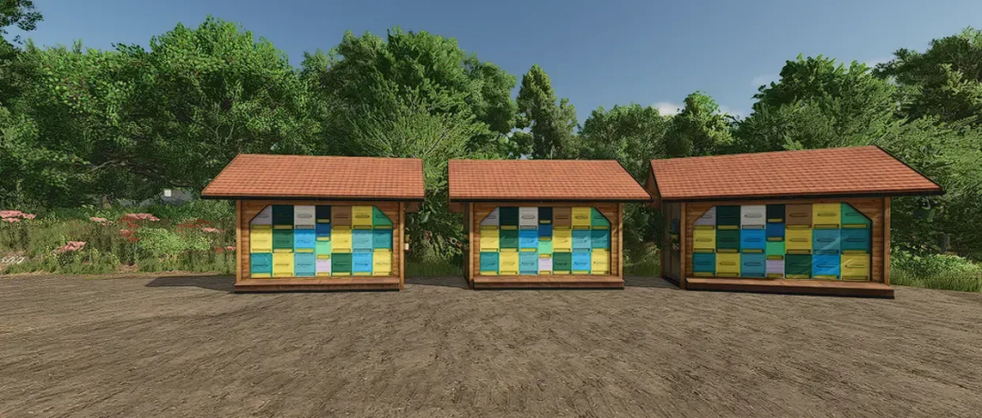 Bee House with Palett Spawner mod in Farming Simulator 25, featuring three colorful beehives in a lush setting.