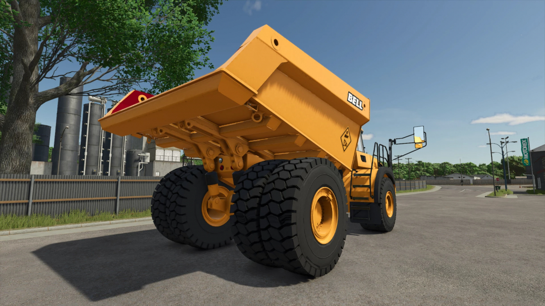 Bell B60E mod for FS25, showcasing a yellow articulated dump truck on a road, featured in Farming Simulator 25.