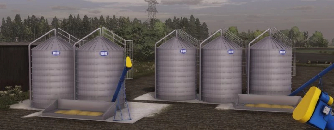 FS22 mods: Bin Pack Zdziechów v1.0.0.0 shows a set of large metal silos situated in a farm environment, enhancing Farming Simulator 22.