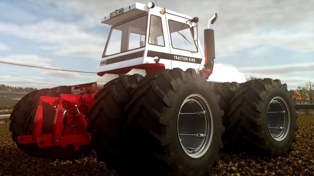 FS25 mod Case IH Traction King tractor in a field, showcasing large tires and red details.