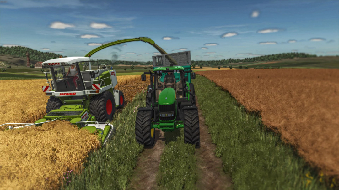 FS25 mod: Claas Jaguar 800 harvesting wheat alongside a green tractor in Farming Simulator 25.