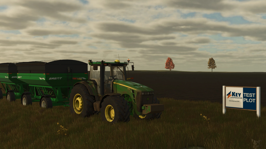 FS25 mod Brent 644 Gravity Wagon v1.0.0.0 attached to tractor in field with test plot sign.