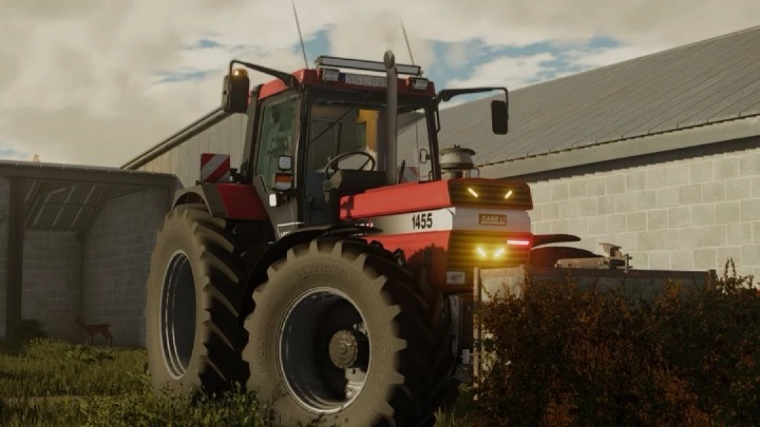 FS25 CaseIH 1455XL tractor mod in Farming Simulator 25, showcasing a red and black design next to a barn.