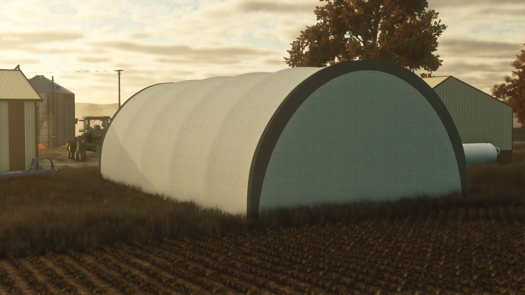 FS25 Fabric Hoop Shed mod v1.0.0.0 in Farming Simulator 25, featuring a large white shed structure on a farm.