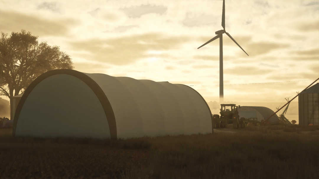 Sunset view of FS25 Fabric Hoop Shed mod in Farming Simulator 25, featuring a wind turbine and a tractor.