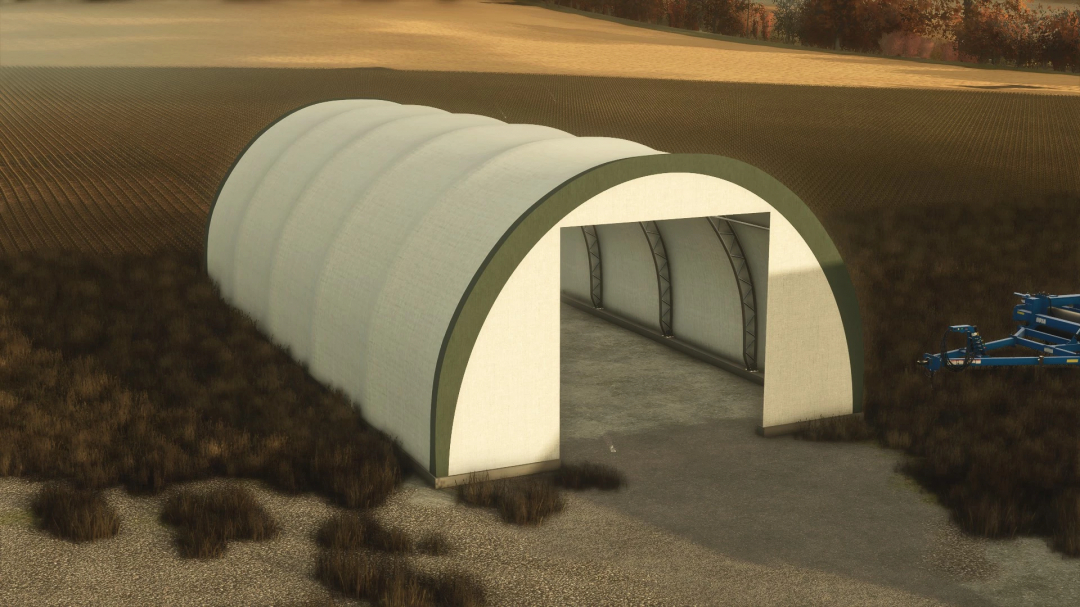 FS25 Fabric Hoop Shed mod in Farming Simulator 25 featuring an open-fronted structure on farmland.