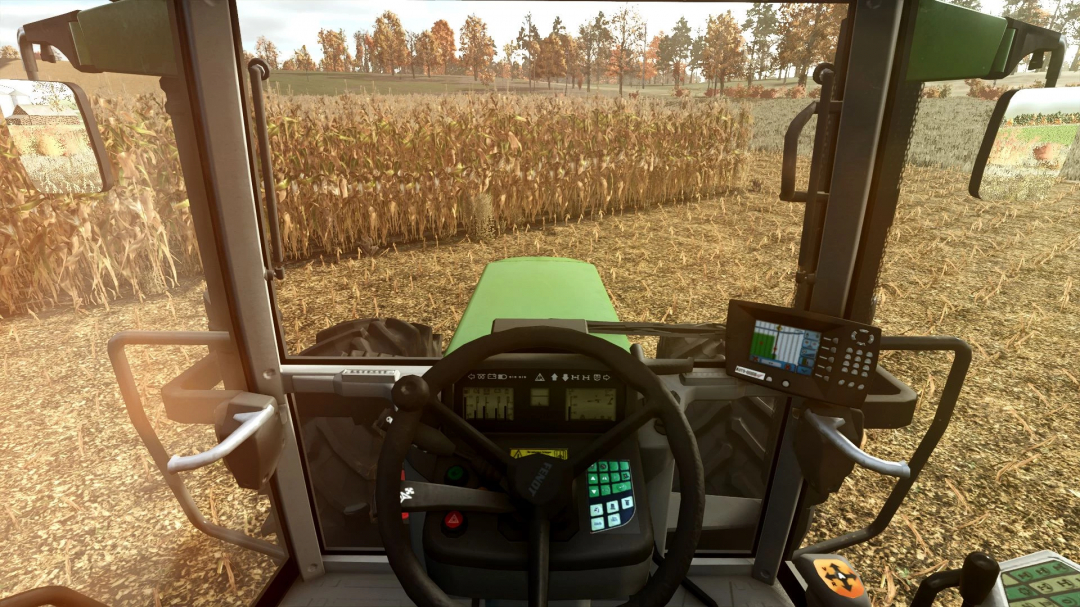 Interior view of Fendt Favorit 900 Series tractor in FS25 mod, showing steering controls and field in background.