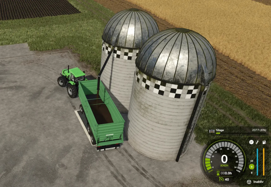 FS25 mod Fermenting Silo v1.0.0.0 with tractor unloading silage into trailer near silos.