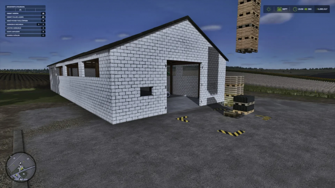 FS25 mod showing a placeable white brick hall with stacks of pallets nearby.