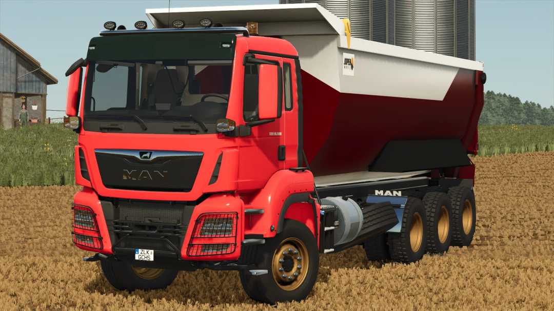 Red MAN TGS Dumper Truck mod in FS25 game, parked on a farm field.