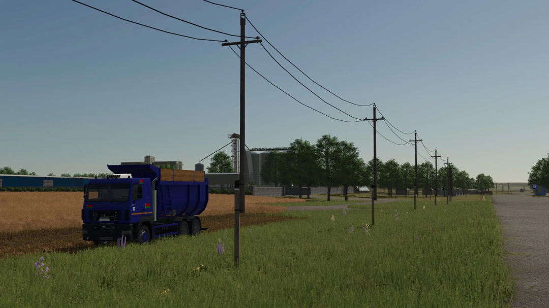 MAZ-6501 20m3 truck in FS25 mod on a rural road near a field and power lines.