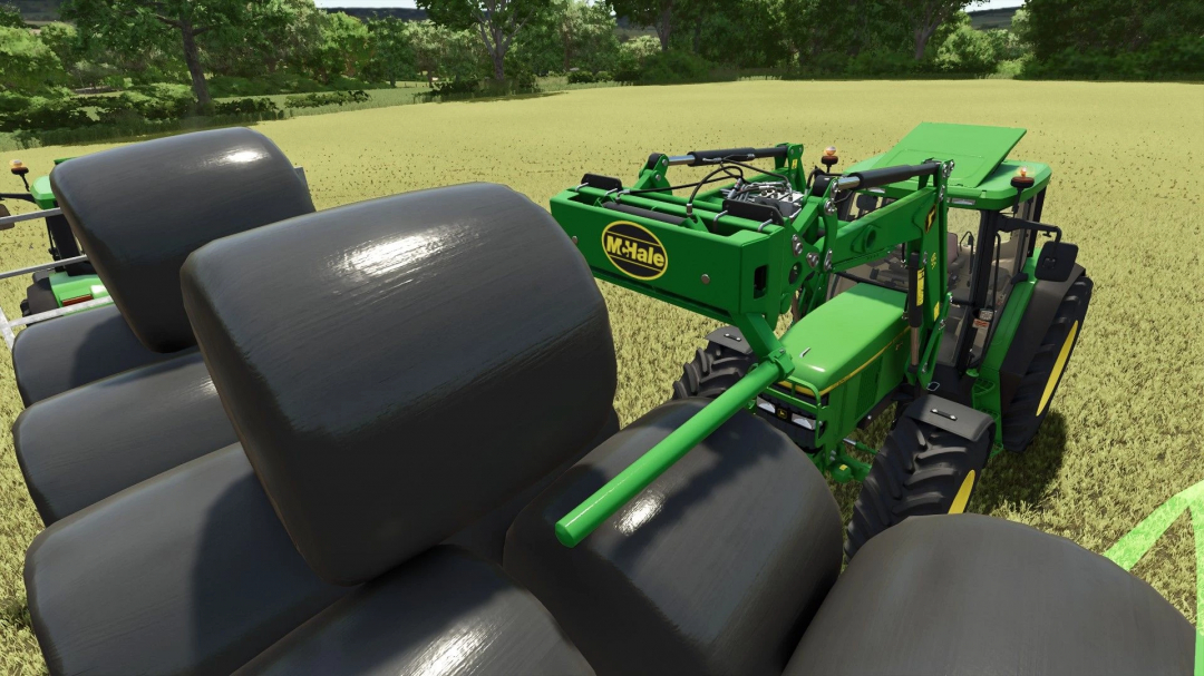 FS25 mod: McHale 691 v1.0.0.1 bale handler on tractor in field, Farming Simulator 25.