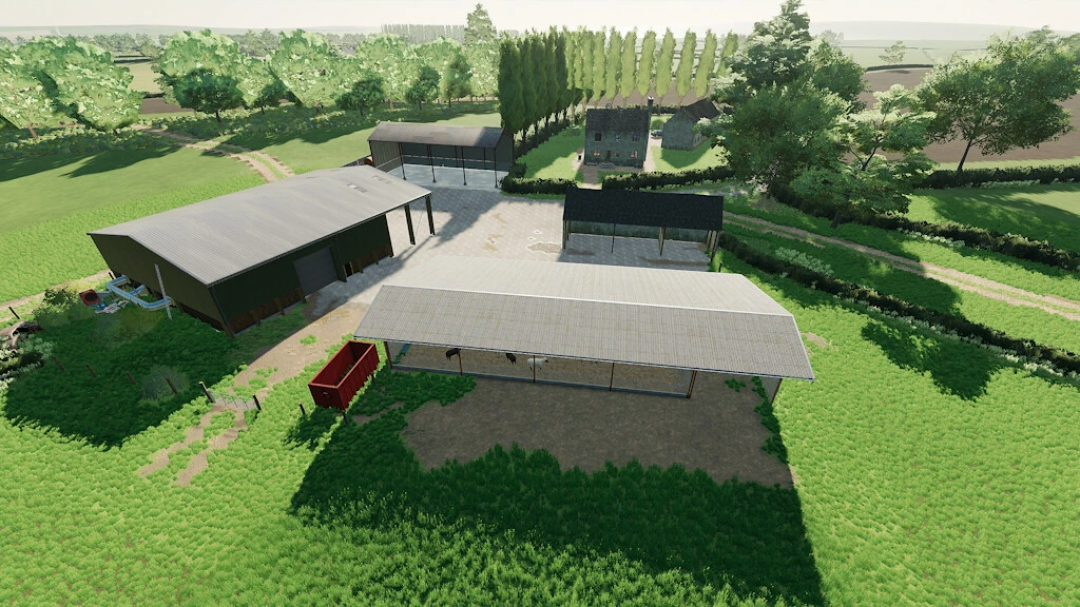 Aerial view of Pidnell Map farm buildings in FS22 mod, showcasing barns and surrounding greenery.