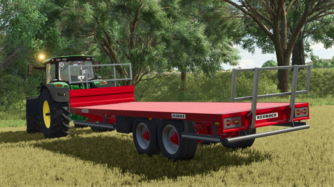 FS25 mod Redrock 24ft Bale Trailer v1.0.0.0 with tractor in a field.