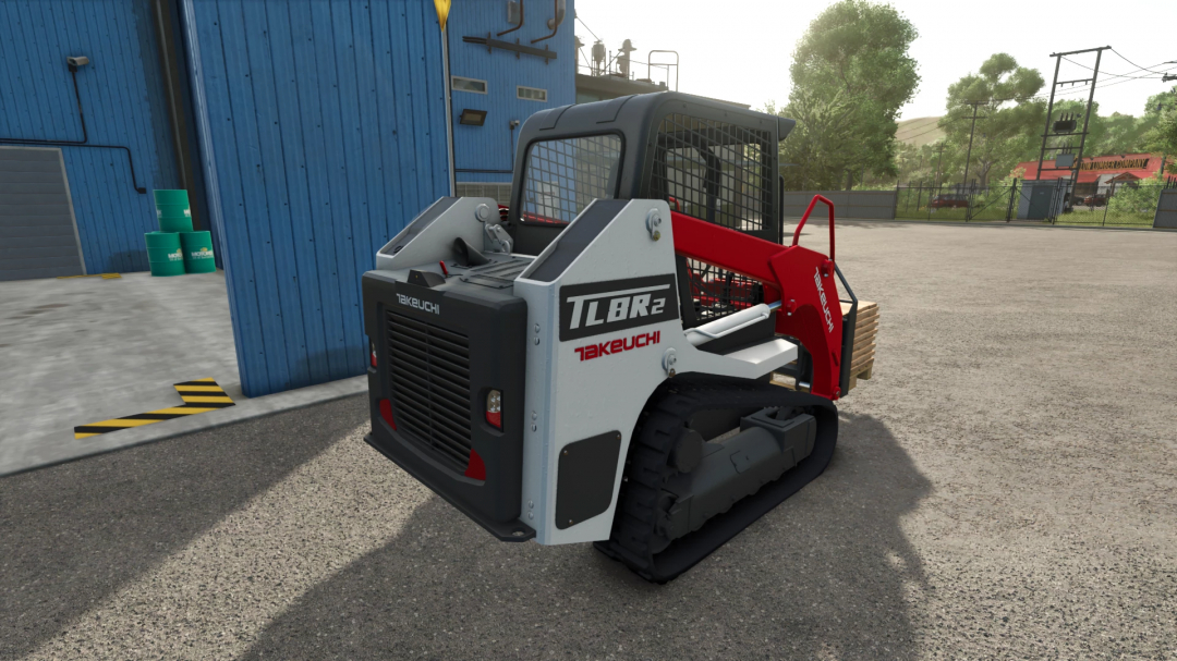 Takeuchi TL8R2 skid steer mod in FS25 by a blue building.