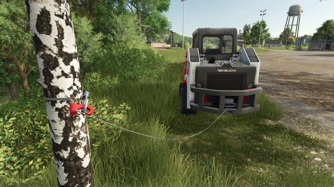 Takeuchi TL8R2 mod in FS25, attached to a tree with a cable in a scenic landscape.