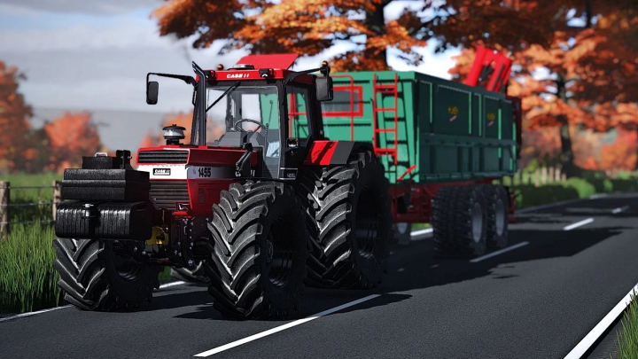 fs25-mods, Case IH 1455 XL Turbo tractor mod in FS25, towing a green trailer on a scenic road with autumn trees.