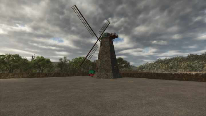 fs25-mods,  Old English Windmill mod in Farming Simulator 25, set under a cloudy sky with trees in the background.