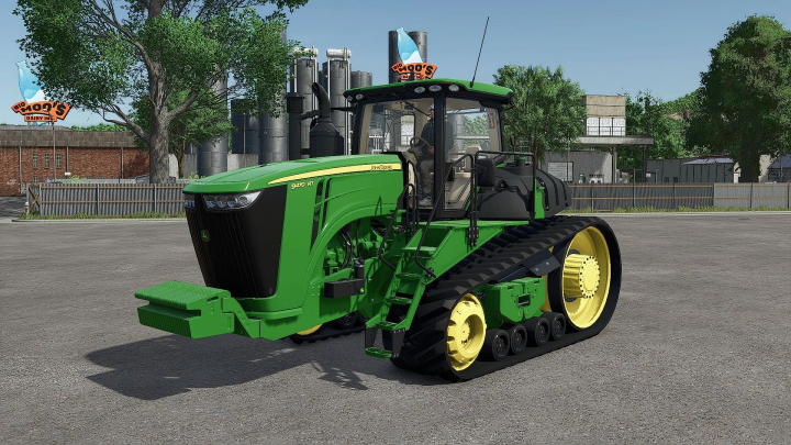 fs25-mods, John Deere 9RT Series 2015 mod in FS25, showcasing a green tractor with track wheels against an industrial background.