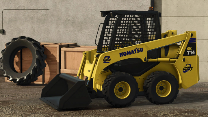 fs25-mods,  Komatsu SK 714 mod for FS25 showcasing a yellow skid steer loader next to tires and crates.