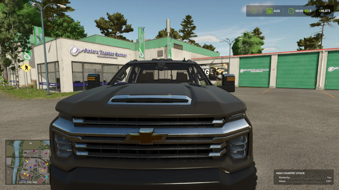 FS25 mod Chevrolet Silverado 2500 High Country in front of Axle's Tractor Center.