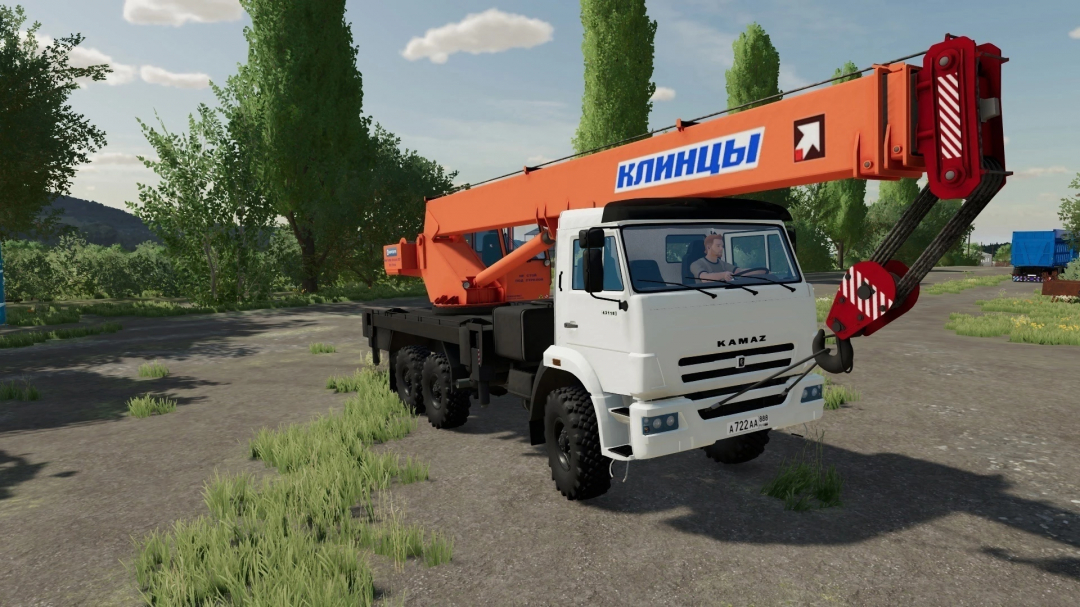 KamAZ Klintsy crane truck mod in Farming Simulator 22, version 5.0.0.0, parked on a rural road surrounded by trees.