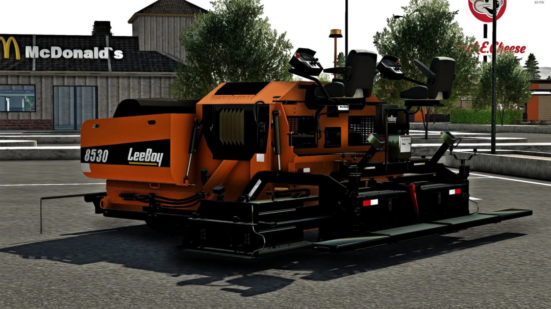 Lee Boy 8530 paver mod in FS22 near McDonald's. Farming Simulator 22 mods enhance gameplay.