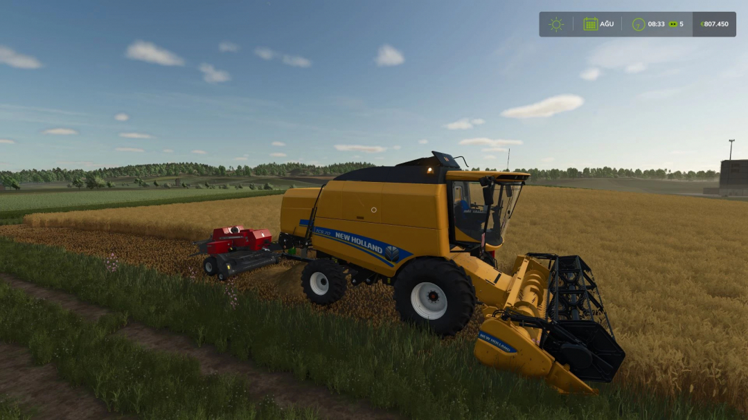 FS25 mod: New Holland TC5 Series harvester working in a wheat field.