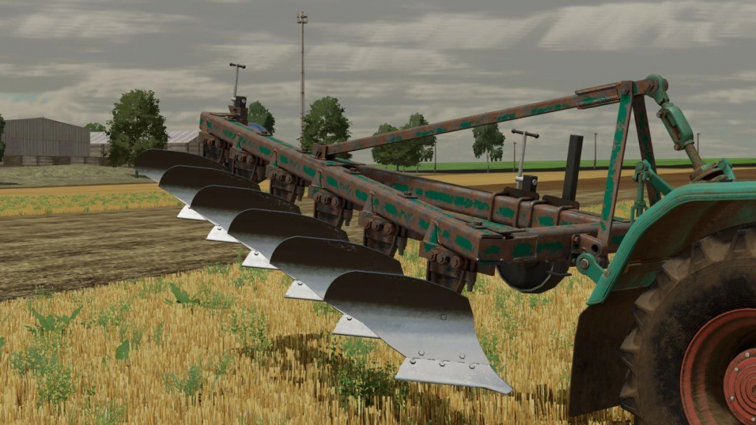 FS22 mods - PLN 6-35 v1.0.0.0 plow attached to a tractor in a field in Farming Simulator 22.