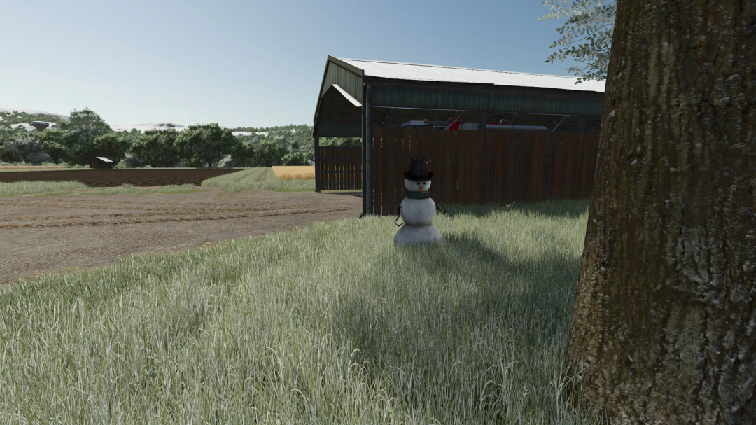 Placeable snowman near barn in FS25 mod Pack v1.0.0.0, adding charm to Farming Simulator 25 landscape.