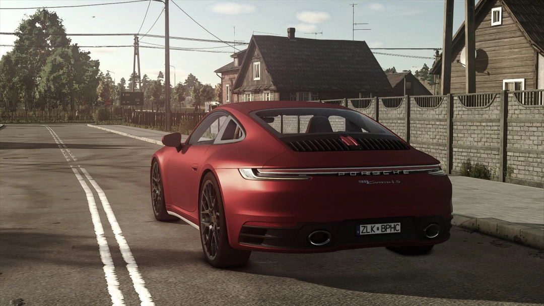 Porsche Carrera 4S mod in FS25, showcasing a sleek red sports car in a rural setting. Perfect addition to Farming Simulator 25 mods.