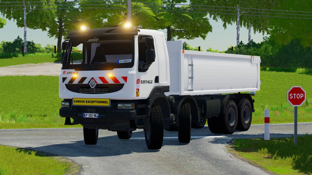 Renault Kerax Ampiroll truck mod in FS22 on a rural road with a stop sign.