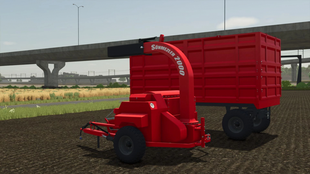 Red Sonmezler 2000 haymaker mod in FS25, placed on a field with a bridge in the background.