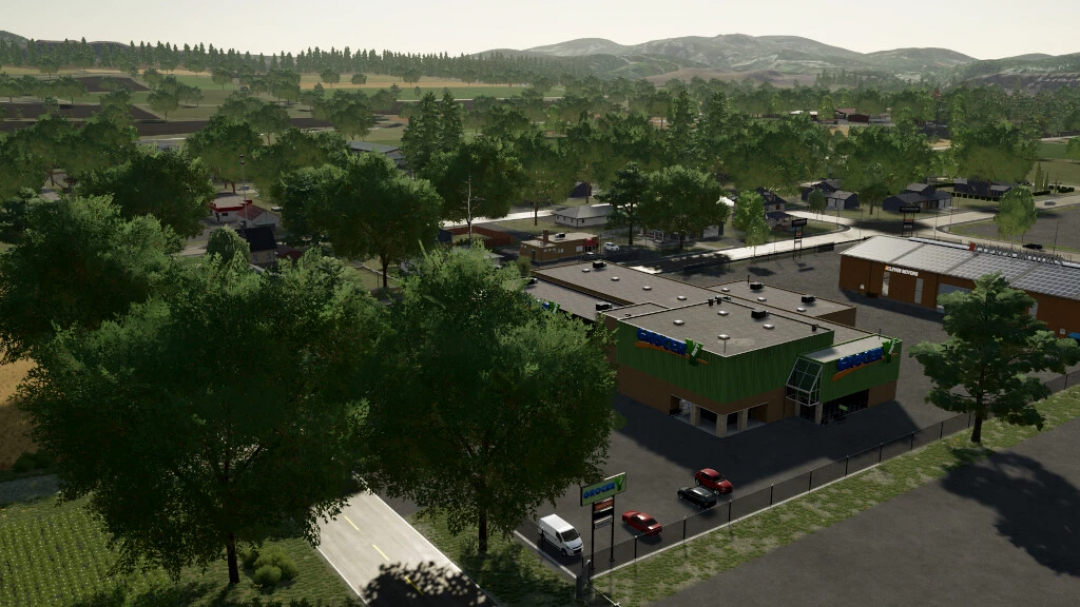 Aerial view of The Ranch, Colorado in FS22 mods showing a grocery store surrounded by trees and various buildings.