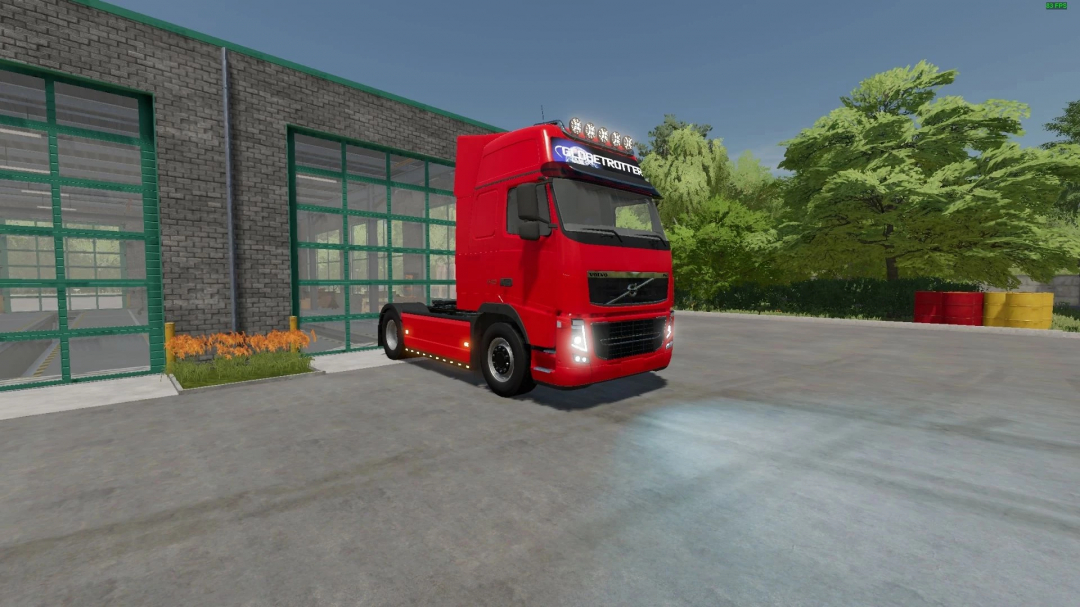 Volvo FH3 truck mod in FS22 parked outside a garage