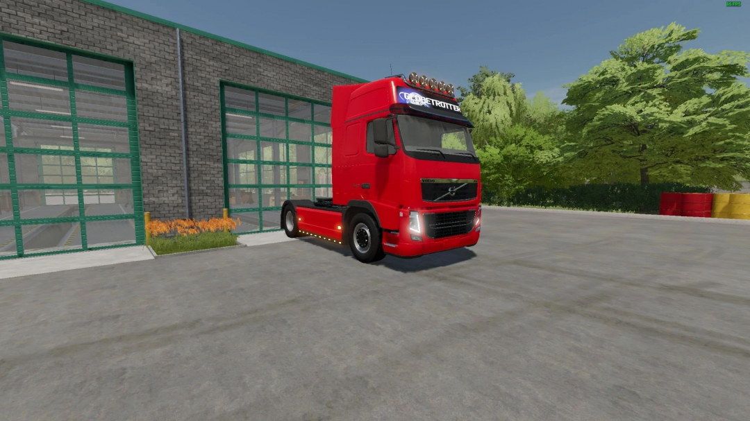 Red Volvo FH3 mod parked outside garage in FS22 mod, Farming Simulator 22.