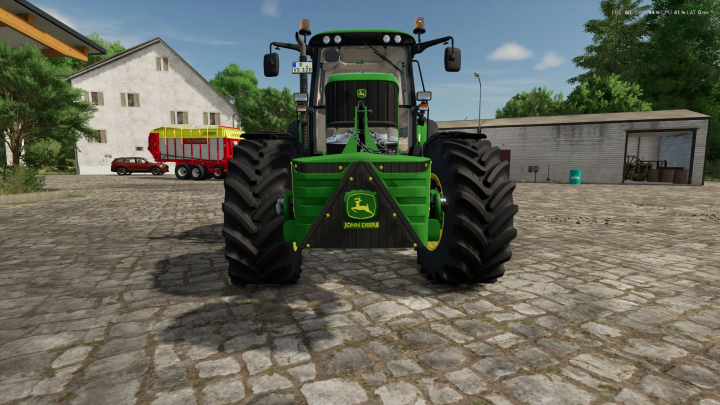 fs25-mods, Front view of a John Deere tractor with 800kg weight mod in FS25, parked on a cobblestone farmyard.