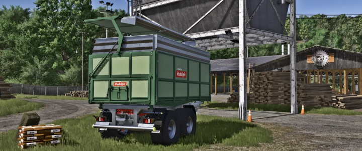 fs25-mods,  FS25 mod Rudolph TDK 301RA v1.0.3.0, a green agricultural trailer, parked near a sawmill in Farming Simulator 25.