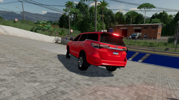 fs22-mods,  Red Toyota SW4 mod in FS22, driving on a paved road. Farming Simulator 22 mods.