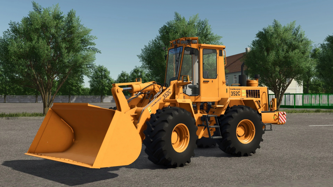 Amkodor-352S v1.0.0.0 mod for FS25, showcasing a yellow front loader parked in a rural area.