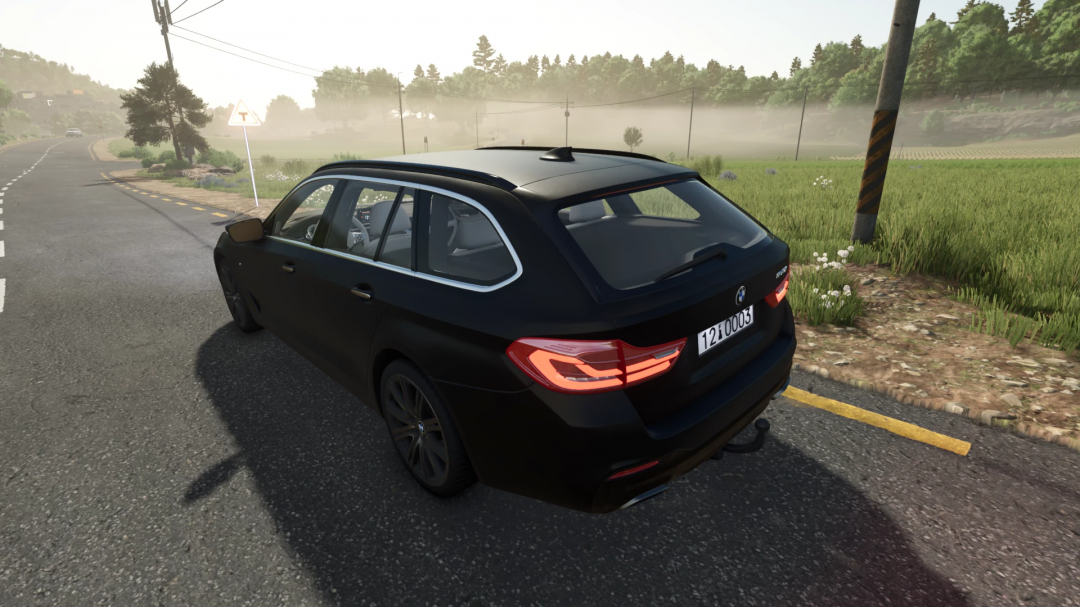 BMW 5 Touring G31 mod in Farming Simulator 25, featuring a black car on a rural road. FS25 mods enhance gameplay.