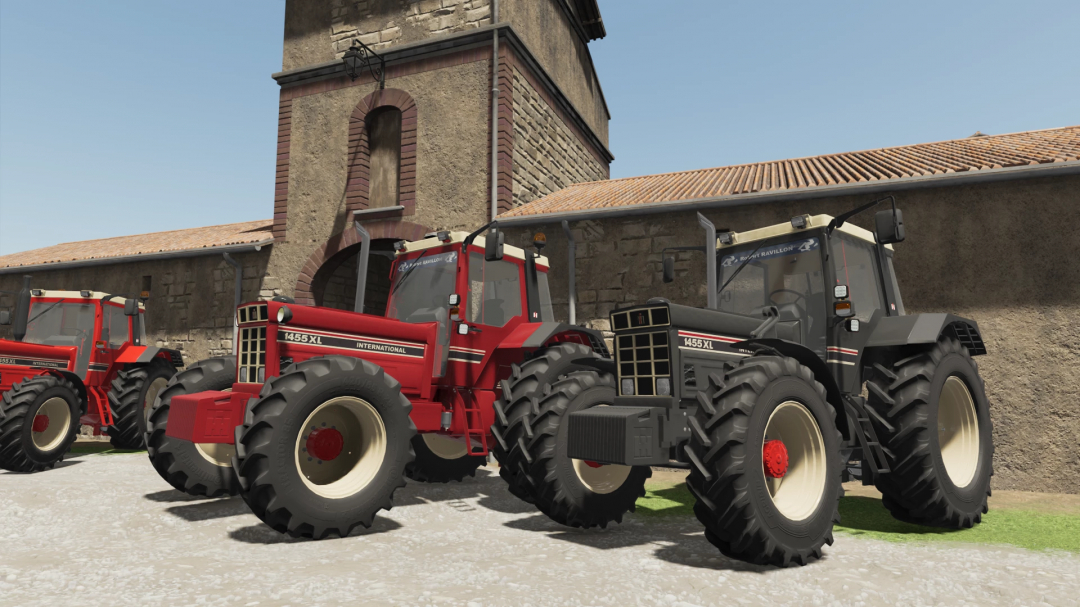 Two International 1455XL tractors in Farming Simulator 22 mod, displayed near a rustic building.