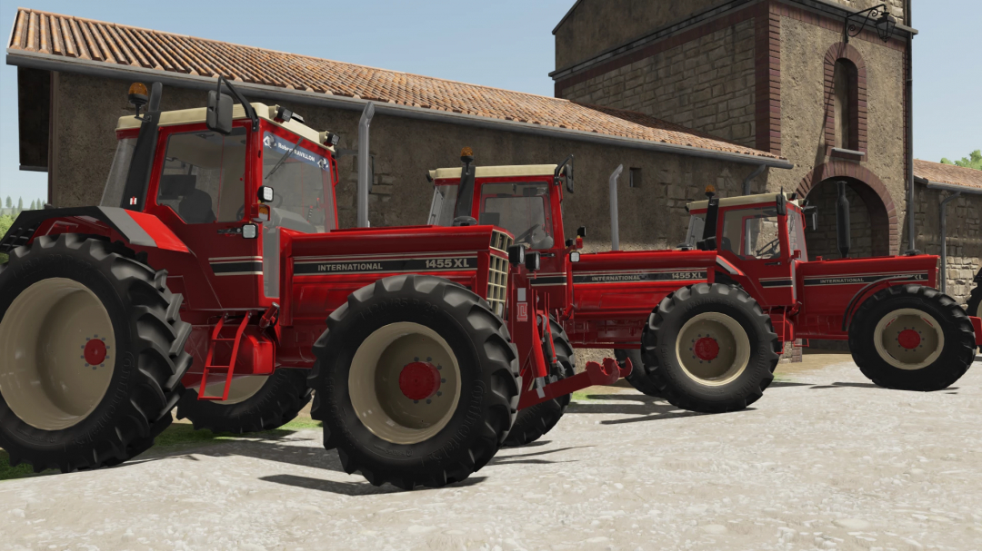 FS22 mod International 1455XL tractors parked outside a rustic building in Farming Simulator 22.