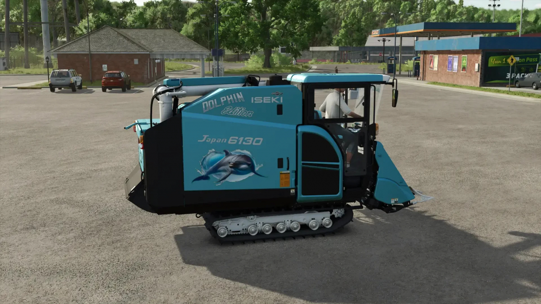 FS25 mod Iseki HJ6130 Dolphin Edition v1.0.0.0 in-game, showcasing a blue machine in a parking lot with trees and buildings in the background.