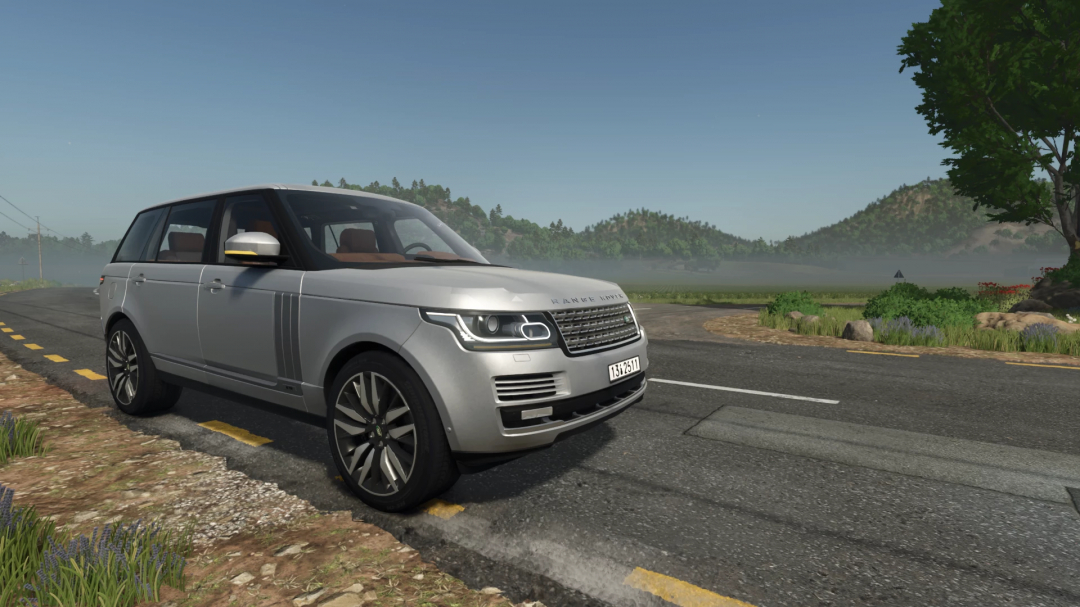 Range Rover LWB mod in FS25, shown on a rural road with scenic hills in the background.