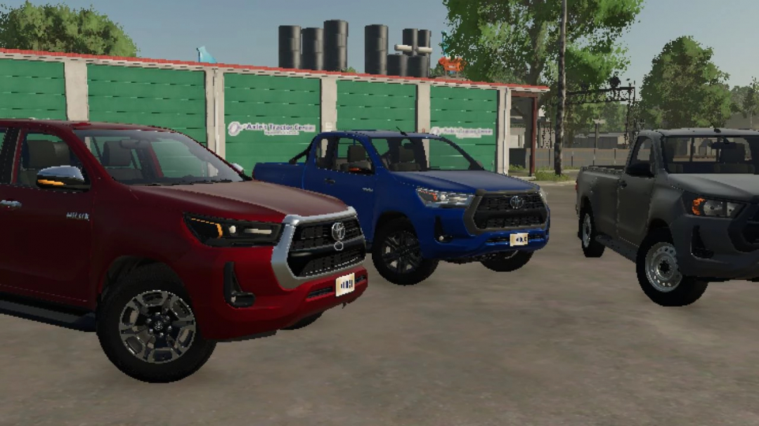 FS25 mod Toyota Hilux 2022 v1.0.0.0 features three pickup trucks in red, blue, and gray in Farming Simulator 25.