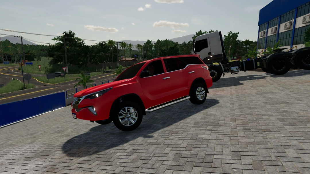 Red Toyota SW4 mod in FS22 parked near a truck, showcasing Farming Simulator 22 mods.