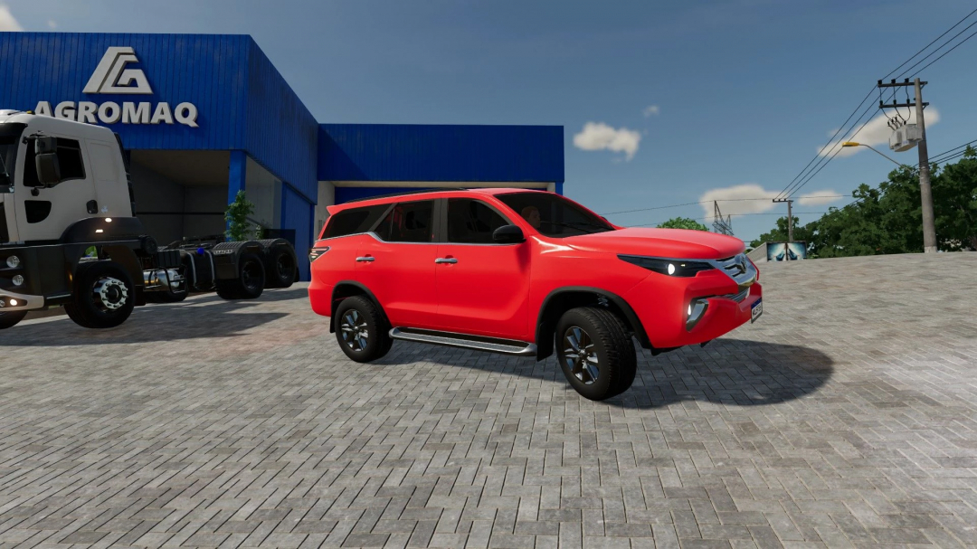 Red Toyota SUV in Farming Simulator 22 mod, parked in front of a blue building with a truck nearby.