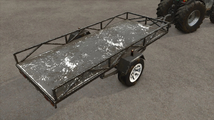 fs25-mods,  Lizard Self-Made Trailer mod in FS25, showcasing a weathered metal frame and single axle on a concrete surface.